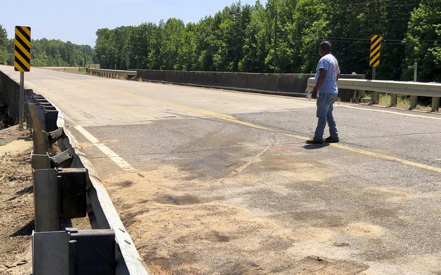 Alejandro Estrejo Resendiz stands at the spot where a van he was driving in the early hours of the morning collided with a truck, killing eight people, near Scooba, Miss., on Monday, June 3, 2019. (AP Photo/Jay Reeves)