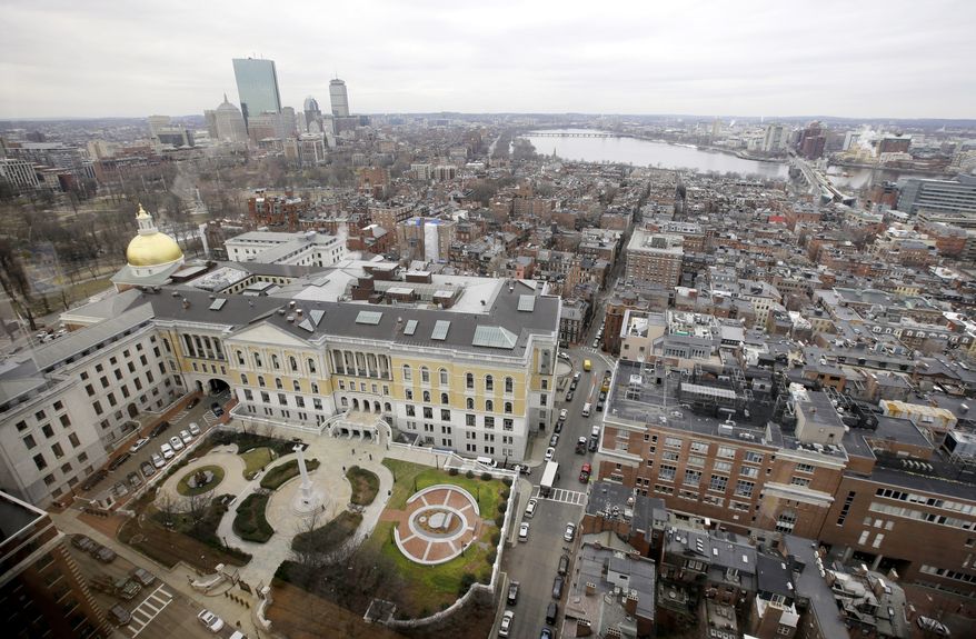 In this Tuesday, Jan. 31, 2017 photo a portion of the Boston Skyline is seen through a window from the office of Massachusetts Attorney General Maura Healey, in Boston. (AP Photo/Steven Senne)