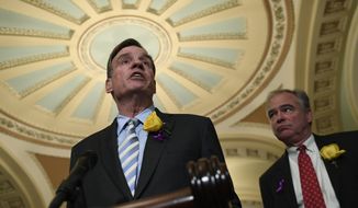 Sen. Mark Warner, D-Va., left, speaks to reporters on Capitol Hill in Washington, in this file photo from Tuesday, June 4, 2019. (AP Photo/Susan Walsh) **FILE**