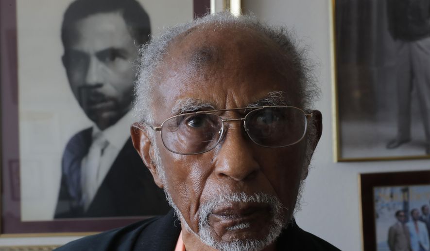 World War II veteran Johnnie Jones, Sr. poses for a portrait at his home in Baton Rouge, La., Tuesday, May 28, 2019. Jones, who joined the military in 1943 out of Southern University in Baton Rouge, was a warrant officer in a unit responsible for unloading equipment and supplies onto Normandy. He remembers wading ashore and one incident when he and his fellow soldiers came under fire from a German sniper. He grabbed his weapon and returned fire along with the other soldiers. It's something that still haunts his memories. (AP Photo/Gerald Herbert)