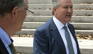 Former Alabama House Speaker Mike Hubbard, right, leaves the Alabama Supreme Court in Montgomery, Ala., on Tuesday, June 4, 2019. An attorney for former Hubbard is asking the Alabama Supreme Court to overturn his 2016 conviction on ethics charges/Montgomery Advertiser via AP)