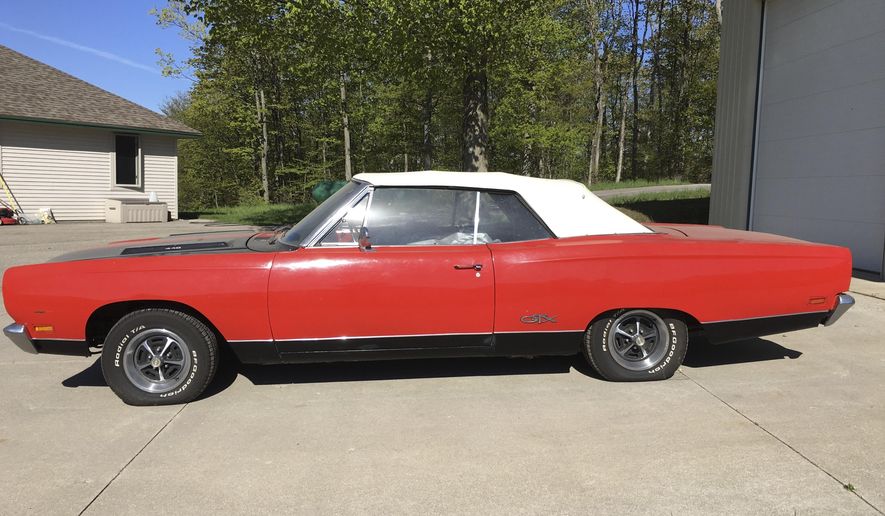 In a May 21, 2019 handout photo from the Leelanau County Sheriff, a 1969 Plymouth GTX convertible is seen. The sheriff's office in northern Michigan is auctioning some rare muscle. Undersheriff Steve Morgan says the car probably was stored for decades and the odometer shows less than 21,000 miles. The two-door GTX is known as a muscle car for its powerful engine. The car was abandoned in a storage building that has changed hands a few times, northwest of Traverse City. Morgan says investigators searched the vehicle's identification number but couldn't find an owner. (Leelanau County Sheriff via AP)