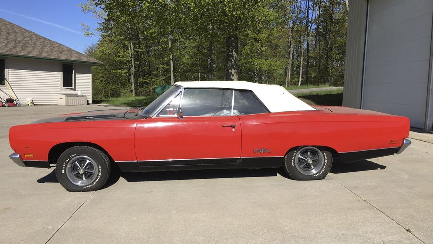In a May 21, 2019 handout photo from the Leelanau County Sheriff, a 1969 Plymouth GTX convertible is seen. The sheriff's office in northern Michigan is auctioning some rare muscle. Undersheriff Steve Morgan says the car probably was stored for decades and the odometer shows less than 21,000 miles. The two-door GTX is known as a muscle car for its powerful engine. The car was abandoned in a storage building that has changed hands a few times, northwest of Traverse City. Morgan says investigators searched the vehicle's identification number but couldn't find an owner. (Leelanau County Sheriff via AP)