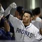 San Diego Padres&#39; Manny Machado, center, reacts after hitting a grand slam during the sixth inning of a baseball game against the Philadelphia Phillies, Monday, June 3, 2019, in San Diego. (AP Photo/Gregory Bull)