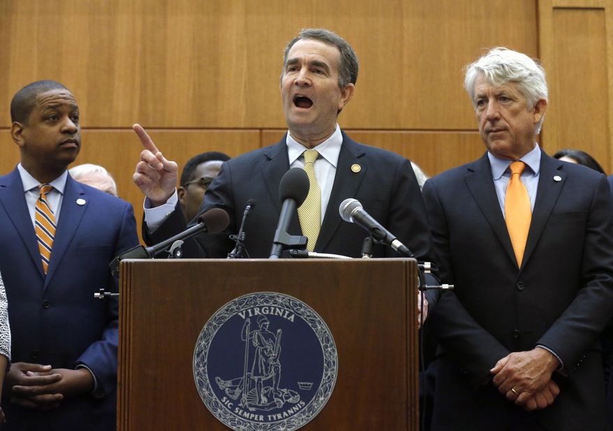 Virginia Gov. Ralph Northam, center, makes remarks as he held a news conference dealing with gun violence while Lt, Gov. Justin Fairfax, left, and Attorney General Mark Herring, right, look on inside the Patrick Henry Building in Richmond, Va. Tuesday, June 4, 2019. Northam is summoning lawmakers back to the state Capitol to consider a package of gun control legislation after Friday's mass shooting in Virginia Beach. (Bob Brown/Richmond Times-Dispatch via AP) ** FILE **