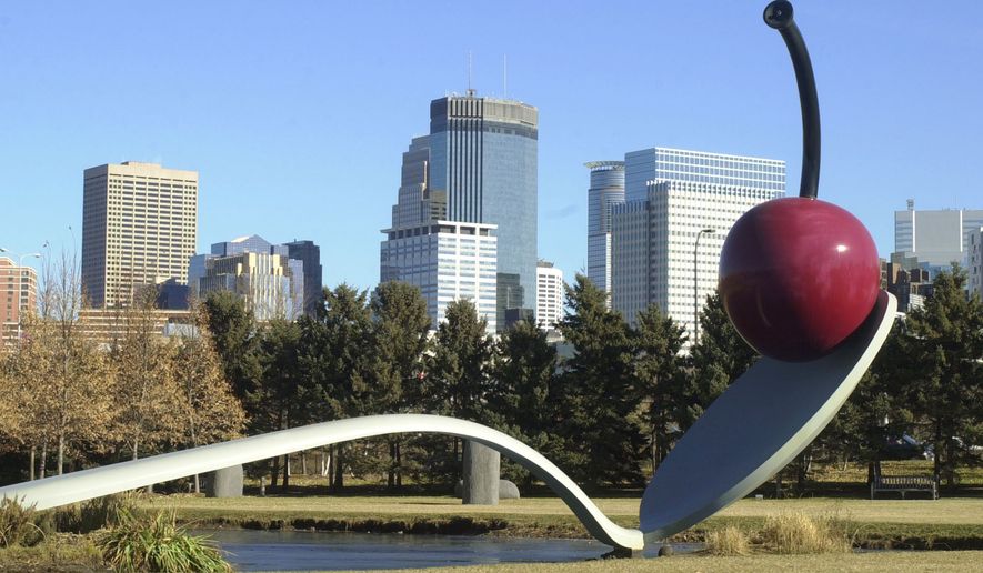 ** FILE ** In this Tuesday, Nov. 19, 2002 file photo, the Minneapolis skyline is seen behind "Spoonbridge and Cherry" by Claes Oldenburg and Coosje van Bruggen in the city's Sculpture Garden near the Walker Art Center. van Bruggen, a critic, art historian and sculptor who collaborated with her artist-husband Claes Oldenburg on his giant sculptures of mundane objects, died Saturday, Jan. 10, 2009. She was 66. (AP Photo/Jim Mone)