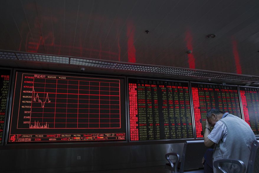 An investor reacts as he monitors stock prices at the brokerage house in Beijing Thursday, June 6, 2019. Asian stocks were mixed on Thursday as traders kept a close watch on impending U.S. tariffs on Mexico amid a standstill in its talks with China. (AP Photo/Andy Wong)