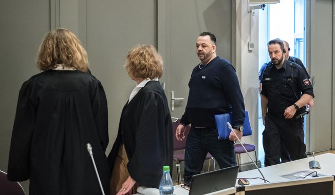 Former nurse Niels Hoegel, 3rd left, accused of multiple murder and attempted murder of patients, arrives for a session of the district court in Oldenburg, Germany, Wednesday, June 5, 2019. (Mohssen Assanimoghaddam/dpa via AP, Pool)