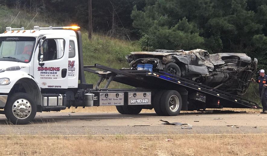 In this photo provided by The Macon Beacon, authorities remove one of several vehicles involved in a fatal crash Wednesday, June 5, 2019, near Scooba, Miss., in the same area where a crash took the lives of eight people two days earlier. Kemper County Sheriff James Moore told The Associated Press that "there will be fatalities" from the wreck on U.S. Highway 45 south of Scooba. (Jeanette Unruh/The Macon Beacon, via AP)