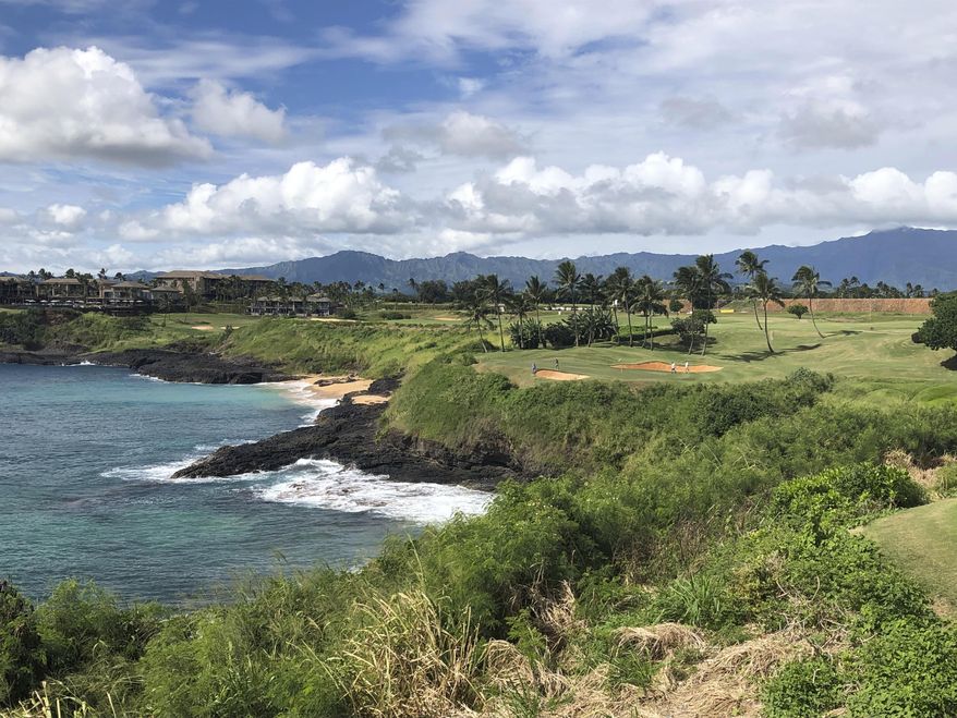 In this Nov. 15, 2018 photo, the 14th hole at the Hokuala Ocean Course in Lihue, Hawaii cuts across the Pacific Ocean on the east side of Kauai. On Tuesday, June 18, 2019, protesters formed a human chain and blocked tourists from using a Kauai highway to access an area they said cannot support a large influx of people, according to reports. (AP Photo/John Marshall) **FILE**
