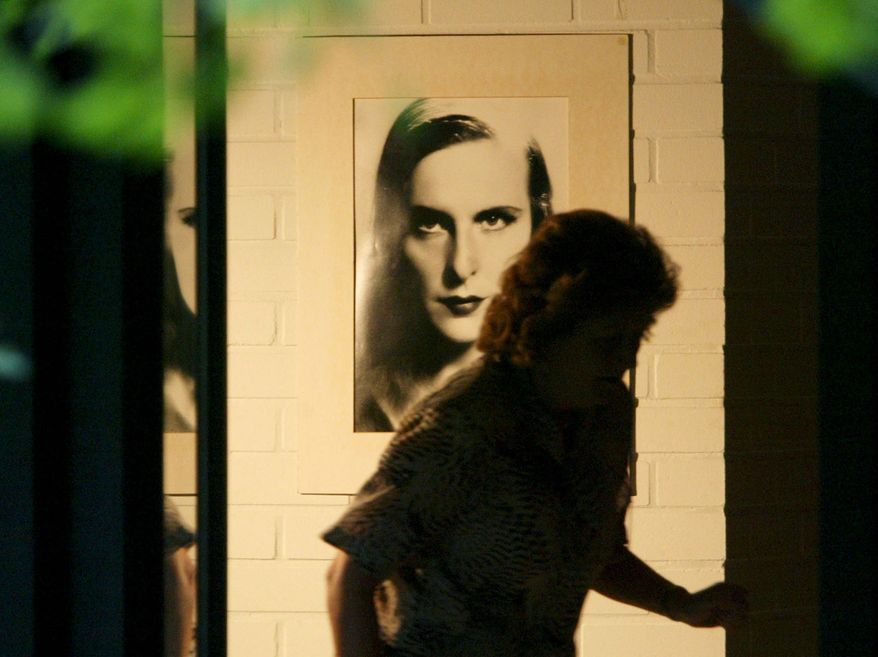 A housekeeper, who refused to be identified, passes by a picture of  famous film director Leni Riefenstahl on the wall in Riefenstahl&#39;s home in Poecking, south of Munich, on Tuesday, Sept. 9, 2003. Riefenstahl, whose hypnotic depiction of Hitler&#39;s Nuremberg rally, &quot;Triumph of the Will&quot;, was renowned and despised as the best propaganda film ever made, died Monday at the age of 101, a German magazine reported Tuesday, Sept. 9, 2003, quoting a long time friend. (AP Photo/Jan Pitman)