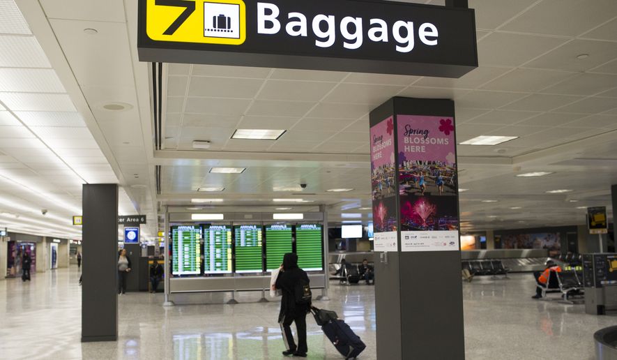 A baggage claim area at Dulles International Airport in Dulles, Va., Tuesday, March 26, 2019. (AP Photo/Cliff Owen)