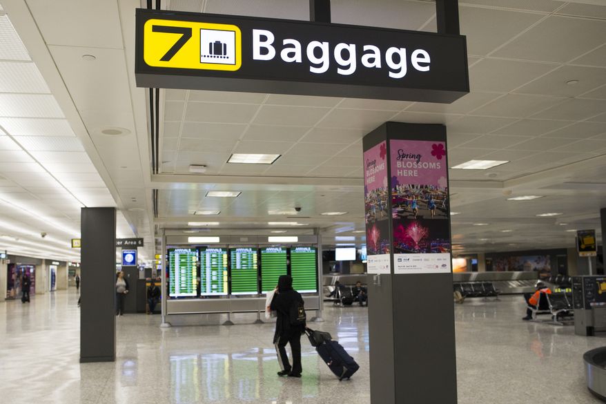 A baggage claim area at Dulles International Airport in Dulles, Va., Tuesday, March 26, 2019. (AP Photo/Cliff Owen)