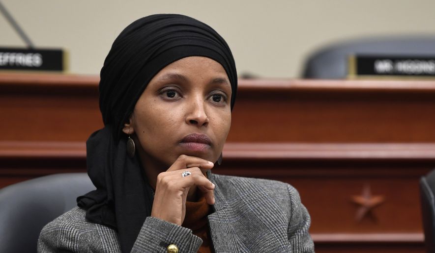 This March 12, 2019, file photo shows Rep. Ilhan Omar, D-Minn., listening as Office of Management and Budget Acting Director Russell Vought testifies before the House Budget Committee on Capitol Hill in Washington. (AP Photo/Susan Walsh, File)