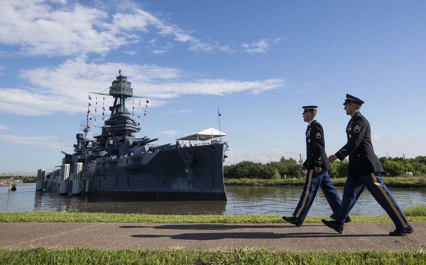 Army Staff Sgt. Jacob Klein, left, and Staff Sgt. Joel Ocasio arrive to the Battleship Texas to participate in a ceremony commemorating the 75th anniversary of D-Day on Thursday, June 6, 2019, in La Porte, Texas. The U.S.S. Texas was part of the D-Day operations in Normandy and is the last remaining battleship to have served during the invasion. (Brett Coomer/Houston Chronicle via AP)
