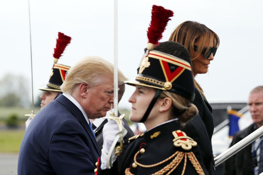 President Donald Trump and first lady Melania Trump board Air Force One on their departure at Caen Airport, Thursday, June 6, 2019, in Caen, France. (AP Photo/Alex Brandon)