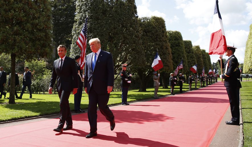 President Donald Trump and French President Emmanuel Macron, arrive to a ceremony to commemorate the 75th anniversary of D-Day at The Normandy American Cemetery, Thursday, June 6, 2019, in Colleville-sur-Mer, Normandy, France. (AP Photo/Alex Brandon)