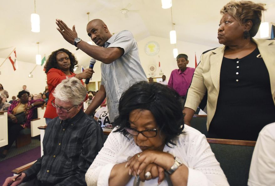 Marvin Haywood, of Benton Harbor, Mich., speaks during a town hall meeting with Gov. Gretchen Whitmer, Wednesday, June 5, 2019, at Brotherhood of All Nations COGIC in Benton Harbor, Mich., to discuss the proposed closing of Benton Harbor High School. Because of school district debt and poor student performance, Whitmer's administration is proposing to close Benton Harbor High School in fall 2020 and send students elsewhere. (Don Campbell/The Herald-Palladium via AP)