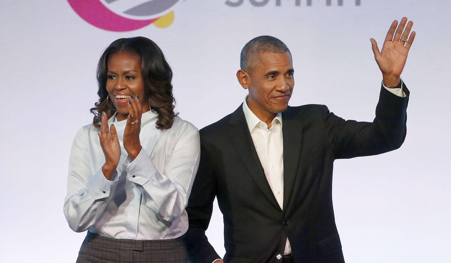 In this Oct. 31, 2017, photo, former President Barack Obama, right, and former first lady Michelle Obama appear at the Obama Foundation Summit in Chicago. (AP Photo/Charles Rex Arbogast) **FILE**