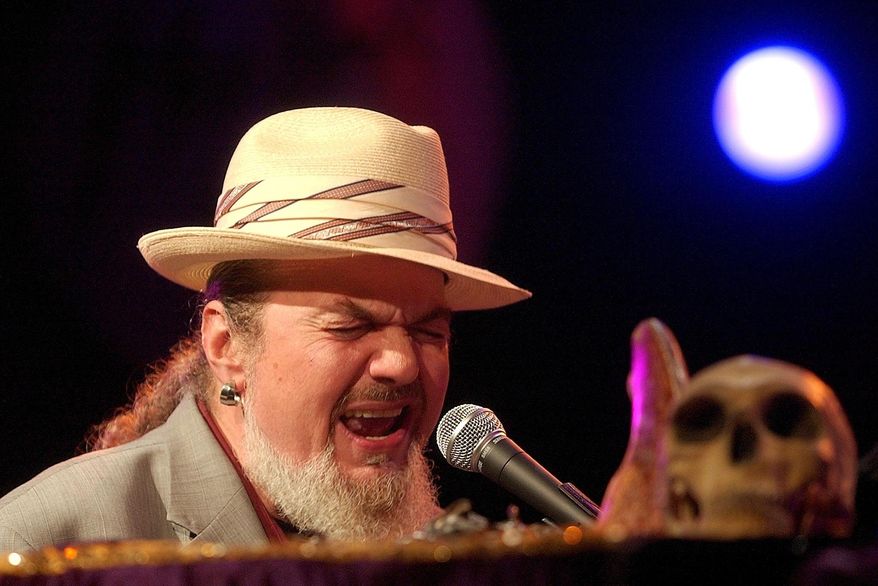 FILE - In this July 6, 2004 file photo, the legendary American Jazz performer, Dr. John, performs on the Auditorium Stravinski stage, during the 38th Montreux Jazz Festival, in Montreux, Switzerland. The family of the Louisiana-born musician known as Dr. John says the celebrated singer and piano player who blended black and white musical influence with a hoodoo-infused stage persona and gravelly bayou drawl, has died. He was 77. A family statement released by his publicist says Dr. John, who was born Mac Rebennack, died early Thursday of a heart attack. (Photo/Keystone/Sandro Campardo, File)
