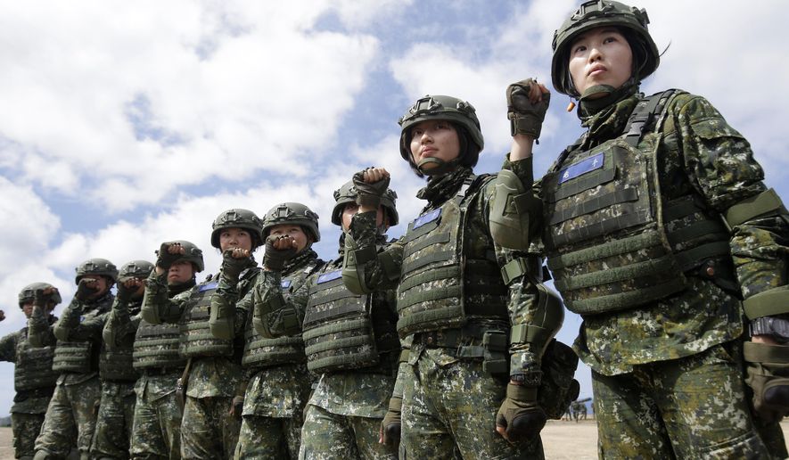 In this May 30, 2019, photo, the first team of Taiwan artillerywomen poses for the press during the annual Han Kuang exercises in Pingtung County, Southern Taiwan. Taiwan has confirmed Thursday, June 6, 2019, that it has asked to purchase more than 100 U.S. tanks, along with air defense and anti-tank missile systems in a major potential arms sale that could worsen frictions between Washington and Beijing. (AP Photo/Chiang Ying-ying) **FILE**