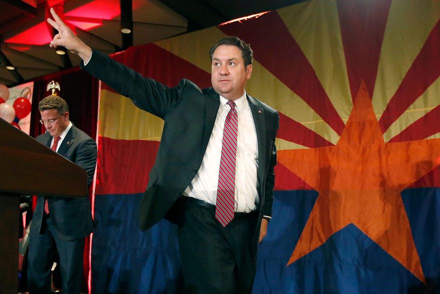 FILE - In this Nov. 4, 2014 file photo, Arizona Republican Attorney General Mark Brnovich waves to supporters at the Republican election night party in Phoenix. Arizona's attorney general is hiring four people dedicated to investigating alleged voter fraud amid accusations without evidence by President Donald Trump and other Republicans of widespread malfeasance in elections. Brnovich hopes his new unit could give people confidence that voter fraud is rare. (AP Photo/Ross D. Franklin, File)