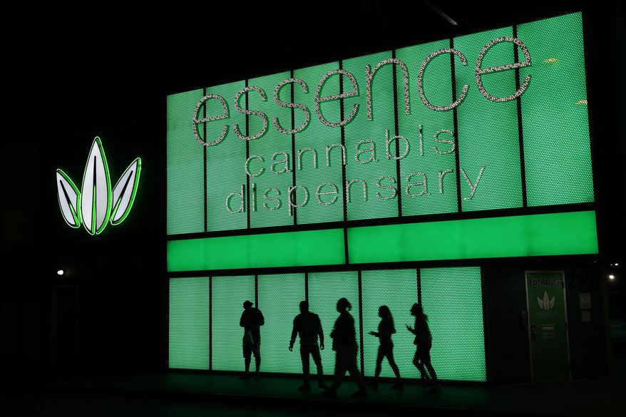 FILE - This April 16, 2018, file photo shows the Essence cannabis dispensary in Las Vegas. Nevada's governor has signed a law Wednesday, June 5, 2019, allowing the state to test out a voluntary, marijuana banking system for three years. (AP Photo/John Locher, File)