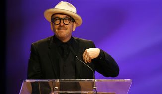 In this Friday, Nov. 20, 2015, file photo, Elvis Costello smiles during a funeral tribute to Allen Toussaint in New Orleans. (AP Photo/Gerald Herbert, file)