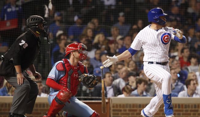 Chicago Cubs&#x27; Victor Caratini, right, watches his three-RBI double during the sixth inning of a baseball game as St. Louis Cardinals catcher Matt Wieters, center, and home plate umpire umpire Manny Gonzalez (79) look on Saturday, June 8, 2019, in Chicago. (AP Photo/Jeff Haynes)
