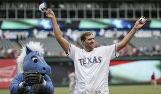 FILE - In this June 5, 2019 file photo, former Dallas Mavericks player Dirk Nowitzki waves to fans after throwing the first pitch before a baseball game between the Baltimore Orioles and the Texas Rangers in Arlington, Texas.  Nowitzki looks relaxed and happy about two months after wrapping up his record 21st season with the same franchise. The big German has been traveling with his family and eating plenty of pizza and ice cream. Nowitzki says he will eventually want to work out again. For now the highest-scoring foreign-born player in NBA history figures he’s at least 20 pounds above his playing weight and not too concerned about it. (AP Photo/Brandon Wade)