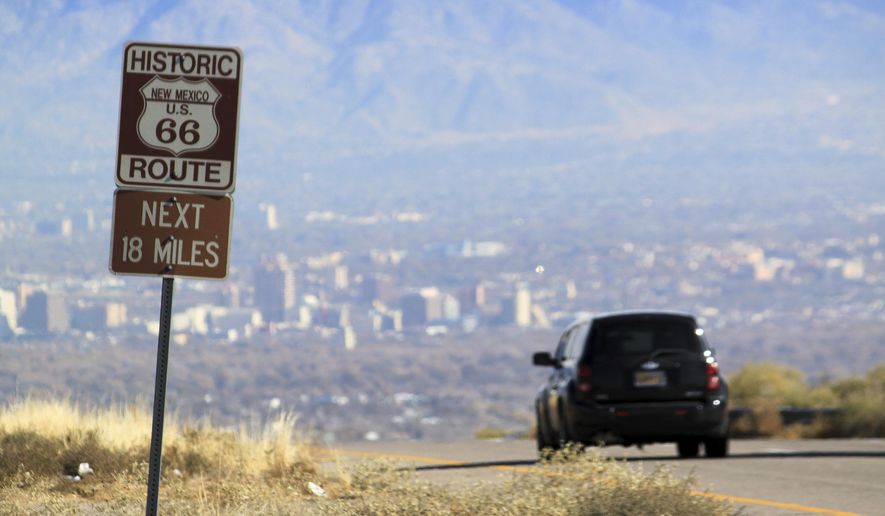 FILE - In this Nov. 19, 2014 file photo a car travels down historic Route 66 toward Albuquerque, N.M. New Mexico's largest city is the latest to embark on upgrades to its portion of the historic Route 66 Highway. (AP Photo/Susan Montoya Bryan,File)