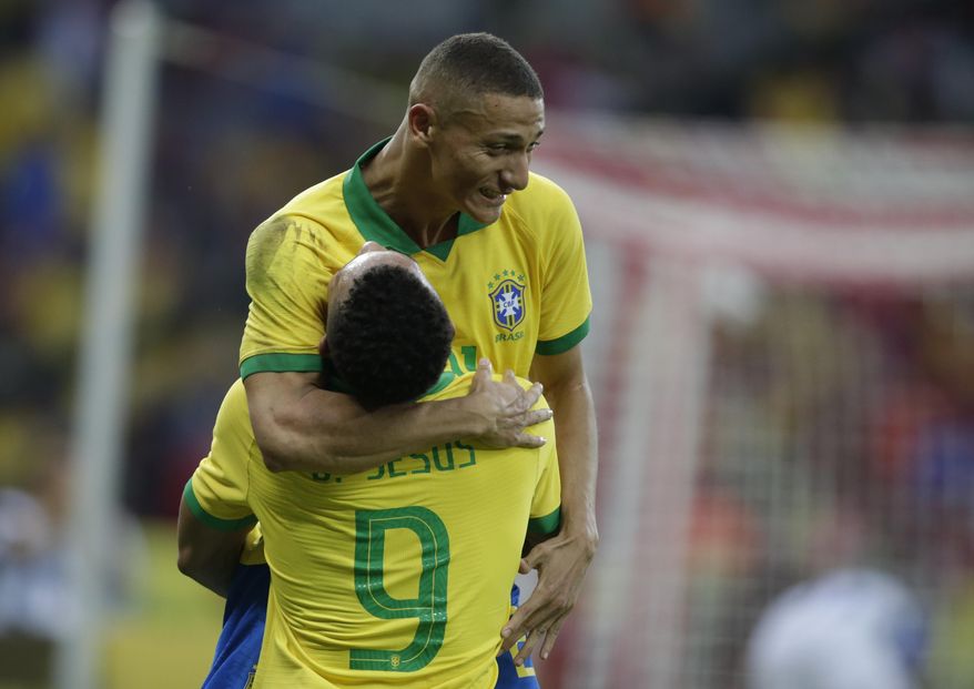 Brazil's Gabriel Jesus, bottom, celebrates scoring his side's 4th goal with Brazil's Richarlison during a friendly soccer match against Honduras at the Beira Rio stadium in Porto Alegre, Brazil, Sunday, June 9, 2019. Brazil opens the Copa America tournament next Friday against Bolivia in Sao Paulo. (AP Photo/Edison Vara)