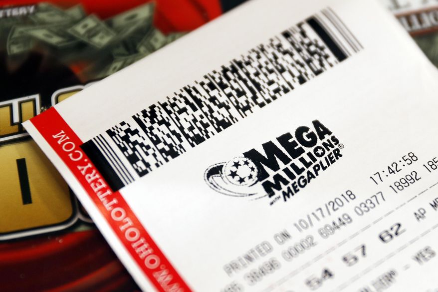 FILE - In this Oct. 17, 2018, file photo a Mega Millions lottery ticket rests on the shop counter at the Street Corner Market in Cincinnati. A lottery ticket worth $530 million in the Mega Millions draw was sold at a liquor store in San Diego, the City News Service reports. (AP Photo/John Minchillo, File)