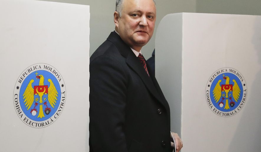 FILE - In this Sunday, Feb. 24, 2019 file photo, Moldova's President Igor Dodon exits a voting cabin in Chisinau, Moldova. A Moldovan court has appointed former prime minister Pavel Filip as interim president, a day after a new government was formed following a months-long political stalemate. The Constitutional Court said Sunday, June 9 that Igor Dodon, who supported the new government, was being relieved of his duties for failing to comply with its ruling to dissolve parliament. (AP Photo/Vadim Ghirda, File)