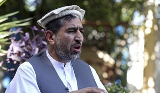 In this Thursday, May 30, 2019, file photo, Ajmal Omar a member of the Nangarhar provincial council speaks during an interview with The Associated Press in the city of Jalalabad, Afghanistan. (AP Photo/Rahmat Gul)