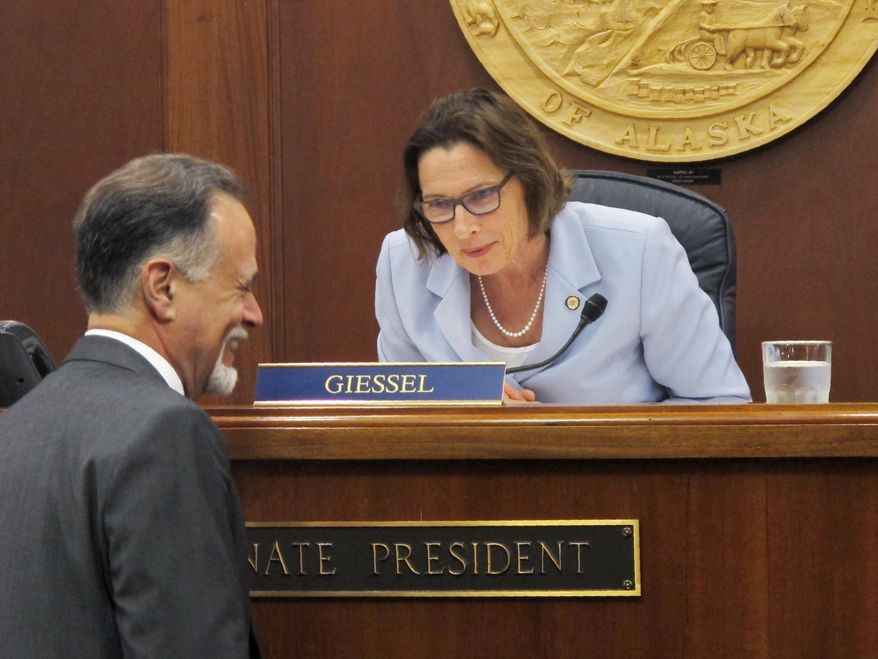 Alaska Senate President Cathy Giessel speaks with Sen. Peter Micciche before the start of the Senate floor session on Monday, June 10, 2019, in Juneau, Alaska. The Senate approved a compromise state operating budget but failed to revive a bill that would pay residents a full dividend this year from the state's oil-wealth fund. (AP Photo/Becky Bohrer)