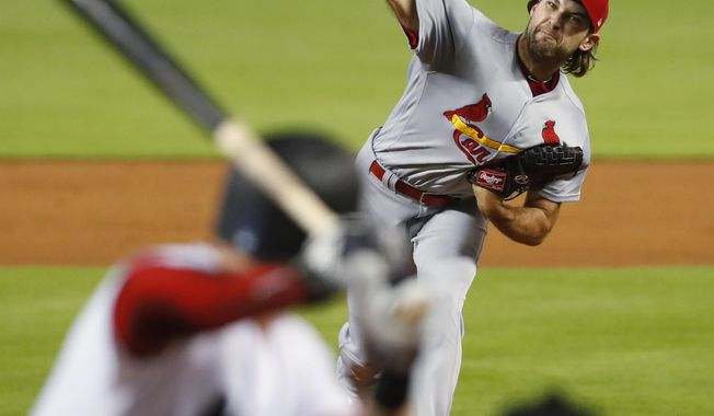 St. Louis Cardinals&#x27; Michael Wacha, top, pitches to Miami Marlins&#x27; Garrett Cooper during the first inning of a baseball game, Monday, June 10, 2019, in Miami. (AP Photo/Wilfredo Lee)