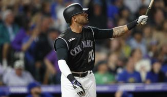 Colorado Rockies pinch-hitter Ian Desmond follows the flight of his solo home run off Chicago Cubs relief pitcher Mike Montgomery in the seventh inning of a baseball game Monday, June 10, 2019, in Denver. (AP Photo/David Zalubowski)