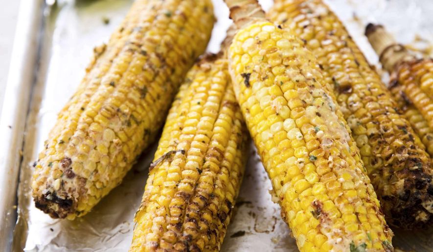 This undated photo provided by America's Test Kitchen in June 2019 shows Mexican Street Corn. This recipe appears in the cookbook "The New Essentials Cookbook." (Joe Keller/America's Test Kitchen via AP)