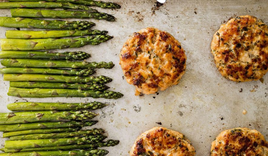 This undated photo provided by America's Test Kitchen in June 2019 shows Salmon Burgers. This recipe appears in the cookbook "One-Pan Wonders." (Daniel J. van Ackere/America's Test Kitchen via AP)