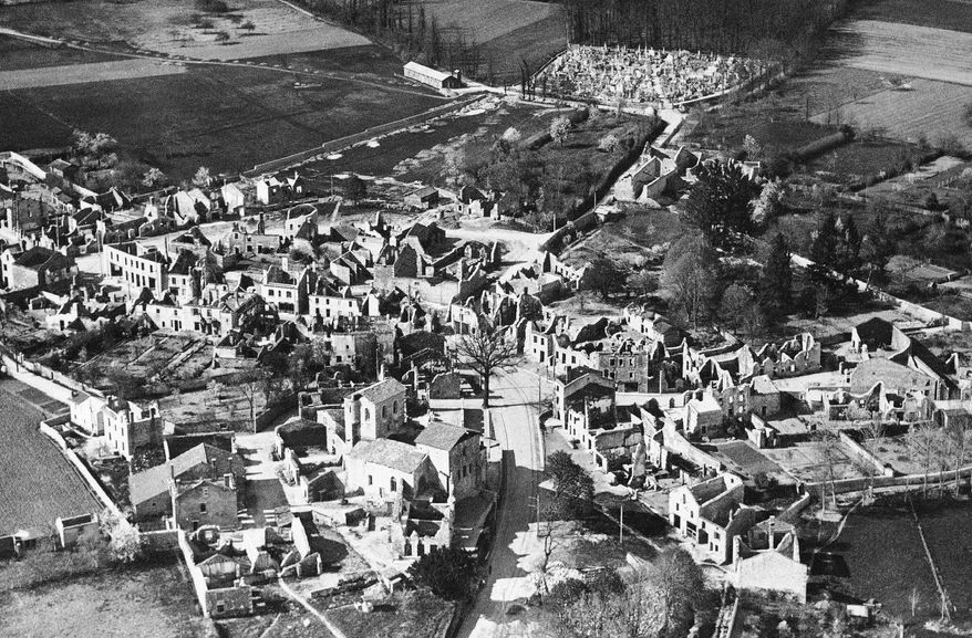 FILE - This Jan. 1, 1953 aerial file picture showing the destroyed village of Oradour-sur-Glane, central France, that is today a phantom village, with burned-out cars and abandoned buildings left as testimony to its history. France remembered on Monday June 10, 2019, the 642 people killed in the small village of Oradour-sur-Glane 75-years ago, in what was the biggest massacre of civilians by Nazi troops during their occupation of the country in World War II. (AP Photo, File)