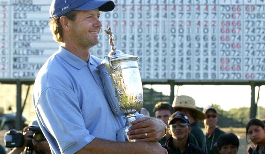 FILE - In this June 20, 2004, file photo, Retief Goosen, of South Africa, holds the U.S. Open Championship trophy at Shinnecock Hills Golf Club in Southampton, N.Y. Goosen was inducted into the World Golf Hall of Fame, Monday, June 10, 2019. (AP Photo/Charles Krupa, File)