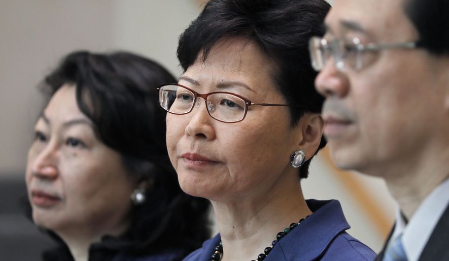 From right, Hong Kong Secretary for Security John Lee, Hong Kong Chief Executive Carrie Lam and Secretary of Justice Teresa Cheng listen to reporters questions during a press conference in Hong Kong Monday, June 10, 2019. Lam signaled Monday that her government will go ahead with proposed amendments to its extradition laws after a massive protest against them. (AP Photo/Vincent Yu)