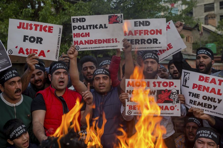 FILE- In this April 14, 2018 file photo, Kashmiri activists hold torches and march in a protest against the rape and murder of an 8-year-old girl, in Srinagar, Indian controlled Kashmir. An Indian court on Monday, June 10, 2019 convicted six people of raping, killing and destroying evidence involving an 8-year-old girl belonging to a Muslim community of nomadic herders that triggered strong protests in the Indian-controlled Kashmir. (AP Photo/Dar Yasin, Fire)