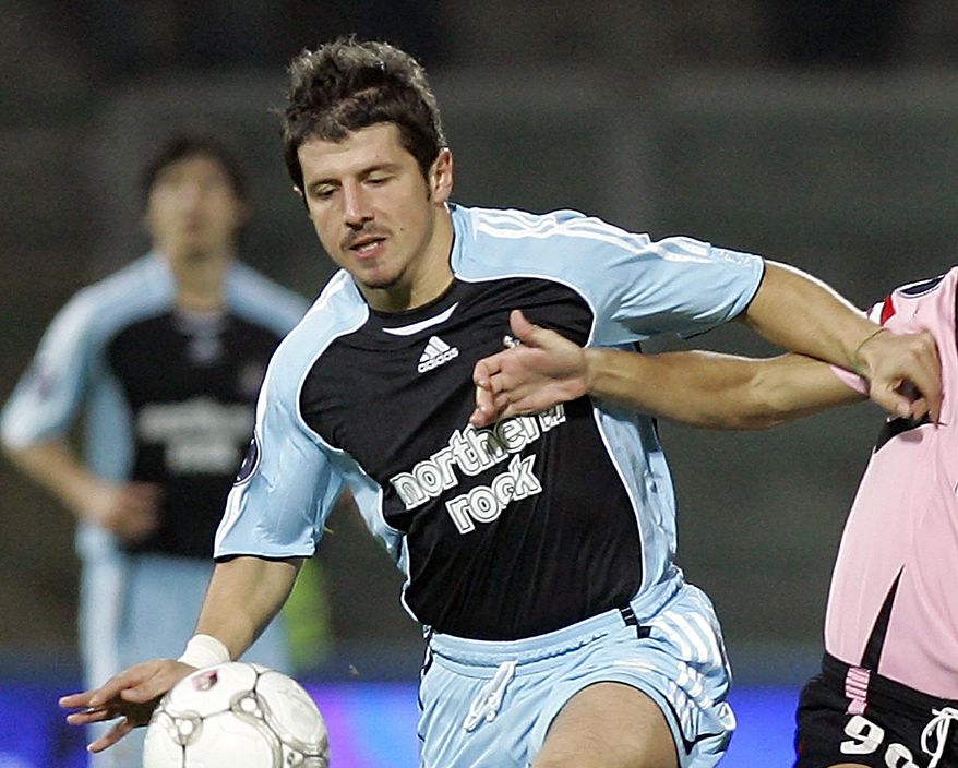 FILE - In this file photo dated Thursday, Nov. 2, 2006, Newcastle midfielder Emre Belezoglu of Turkey, in action during a UEFA Cup soccer match against Palermo, in Palermo, southern Italy. An unidentified man held a cleaning brush up to the face of team captain Emre Belezoglu who was speaking to media, and Turkey has lodged a formal protest Monday June 10, 2019, against authorities in Iceland over the way its national soccer team was treated on its arrival Sunday for an upcoming European Championship qualifying match.(AP Photo/Antonio Calanni, FILE)
