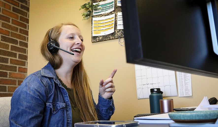 In a Thursday, June 6, 2019 photo, Audrey Nordine, Black Hills Program Coordinator for the Helpline Center, works in her office in Rapid City. (Adam Fondren/Rapid City Journal via AP)