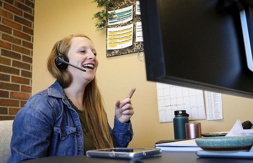 In a Thursday, June 6, 2019 photo, Audrey Nordine, Black Hills Program Coordinator for the Helpline Center, works in her office in Rapid City. (Adam Fondren/Rapid City Journal via AP)