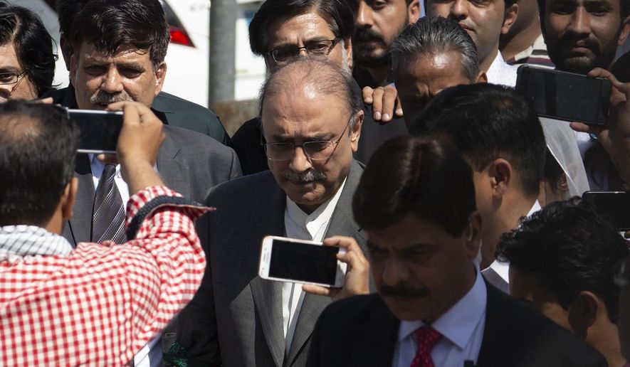 Former Pakistani president and currently a lawmaker in Parliament and leader of Pakistan People's party, Asif Ali Zardari, center, leaves the High Court building, in Islamabad, Pakistan, Monday, June 10, 2019. A Pakistani court has rejected a request by Zardari and his sister Faryal Talpur, for an extension of their bail that would allow them to remain free despite facing a multimillion-dollar money laundering case. (AP Photo/B.K. Bangash)