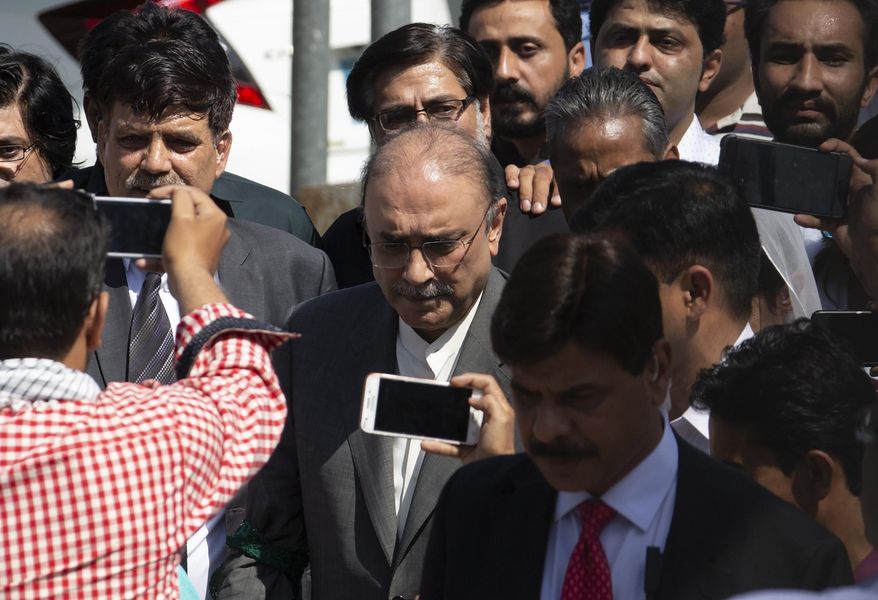Former Pakistani president and currently a lawmaker in Parliament and leader of Pakistan People's party, Asif Ali Zardari, center, leaves the High Court building, in Islamabad, Pakistan, Monday, June 10, 2019. A Pakistani court has rejected a request by Zardari and his sister Faryal Talpur, for an extension of their bail that would allow them to remain free despite facing a multimillion-dollar money laundering case. (AP Photo/B.K. Bangash)