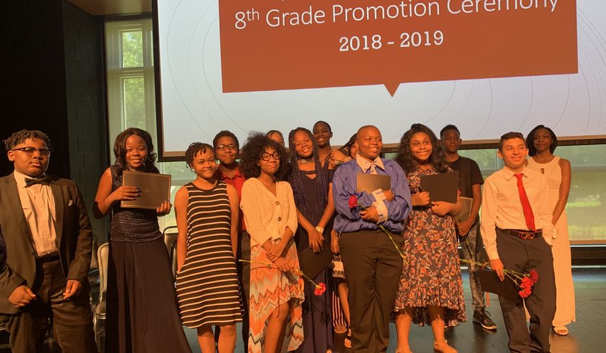 Fourteen students graduated from the eighth grade at Friendship Public Charter School Online on Tuesday. The graduation ceremony was held at the Town Hall Arts Recreation Campus (THEARC) in Southeast Washington. (Sophie Kaplan/The Washington Times)
